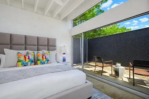 a bedroom with a bed couch and window