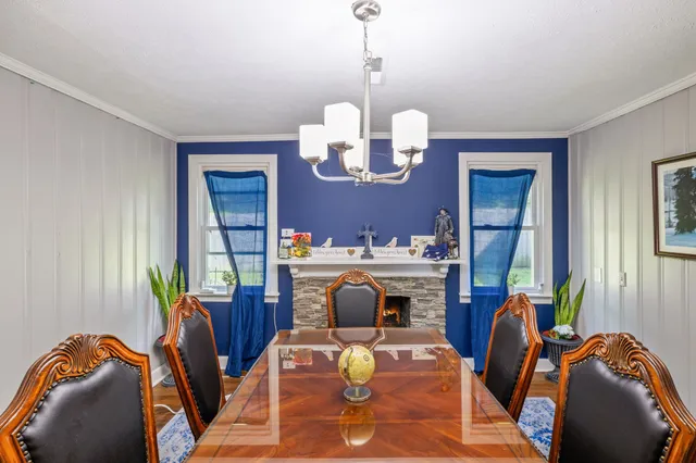 a living room with furniture chandelier and a mirror