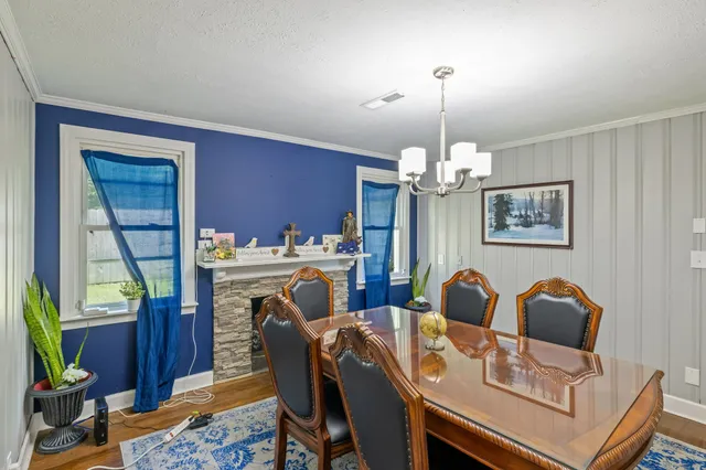 a view of a dining room with furniture and a chandelier