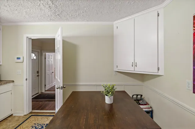 a view of a room with furniture and wooden floor