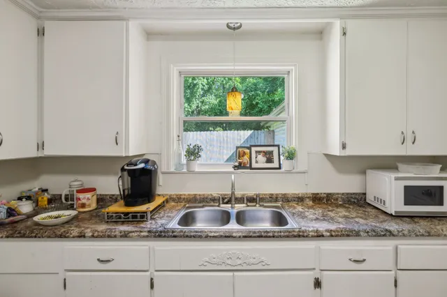 a kitchen with a sink and a refrigerator