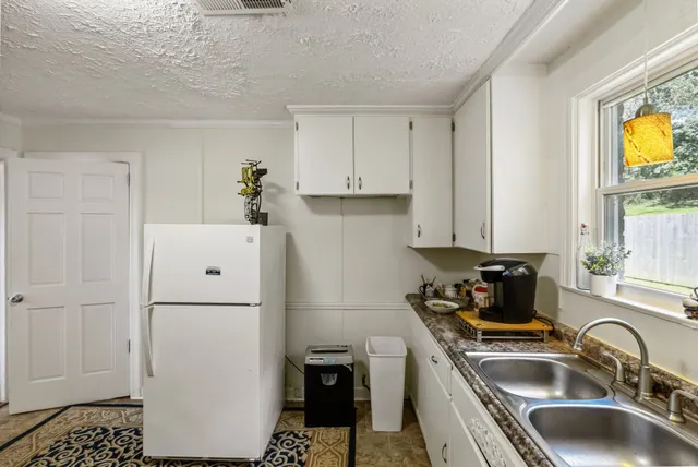 a kitchen with granite countertop a sink and a stove