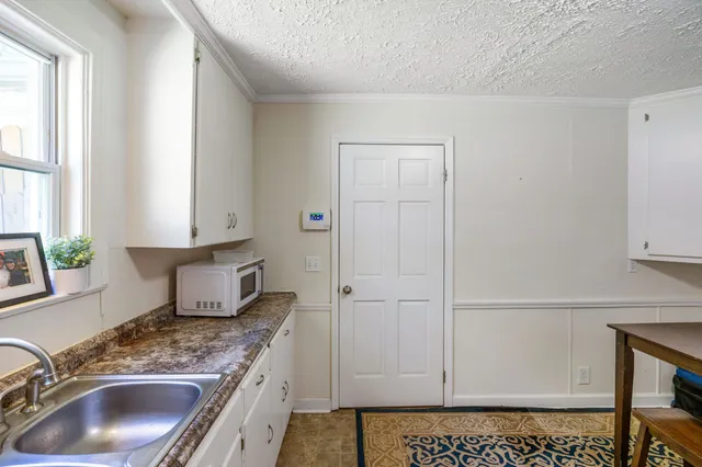 a close view of sink and a microwave