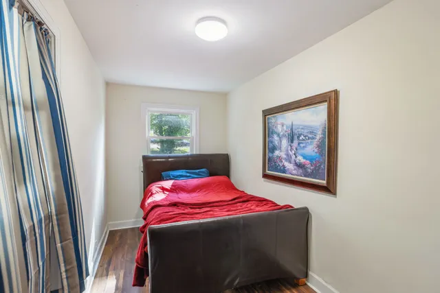 a view of a room with wooden floor cabinet and a window