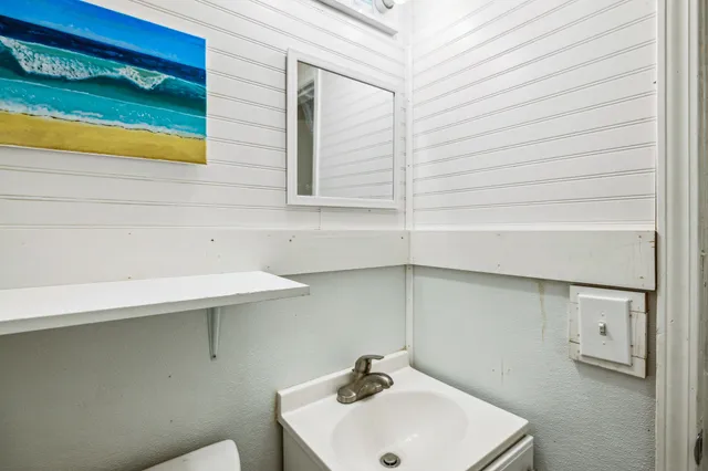 a white toilet sitting next to a small bathroom