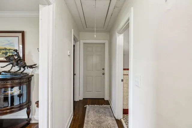 a view of a hallway with wooden floor and closet