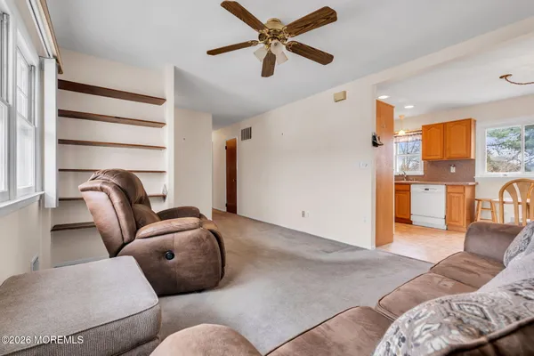 a living room with furniture a couch and a window