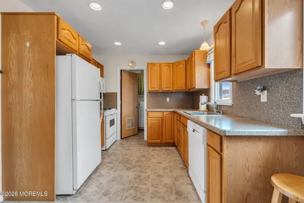 a kitchen with stainless steel appliances granite countertop a refrigerator sink and cabinets