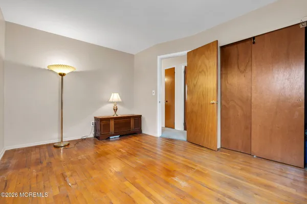a bedroom with a bed and a lamp on table