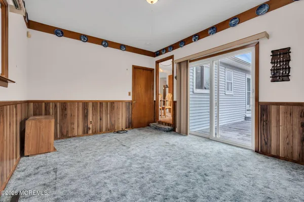 a bedroom with bed painting on the wall and a window