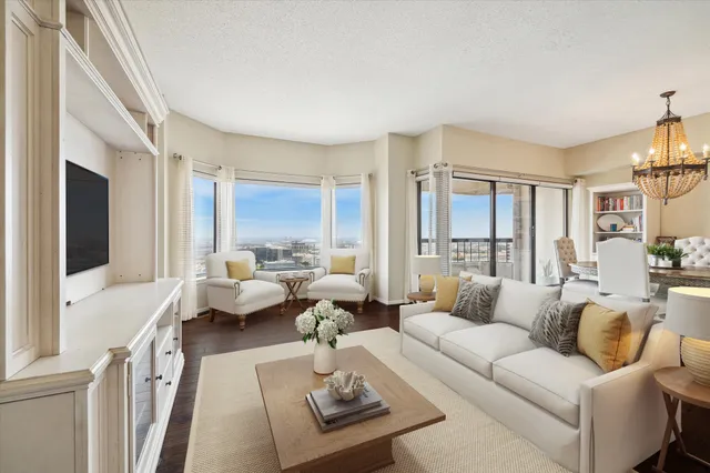 a living room with furniture couches and a flat tv screen