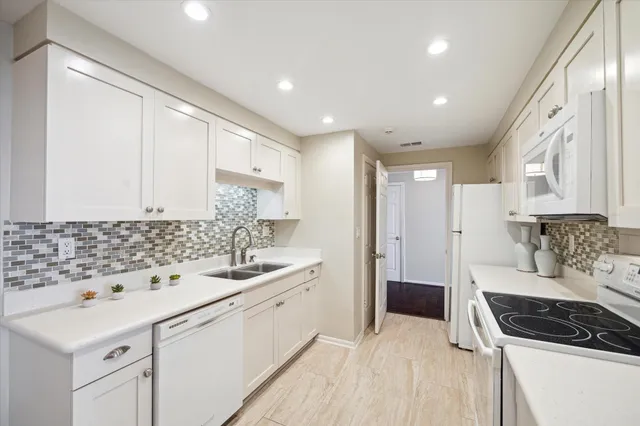 a kitchen with a sink a stove and cabinets