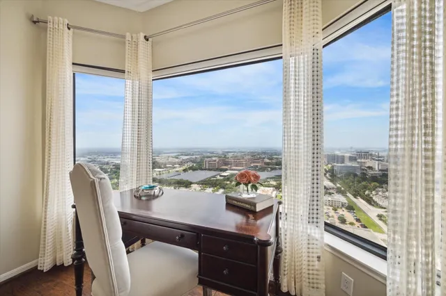 a spacious bedroom with a large bed couch and a potted plant