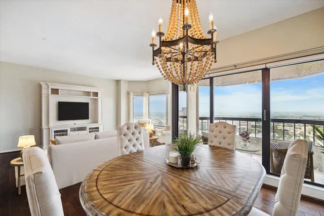 a view of a dining room with furniture wooden floor and chandelier