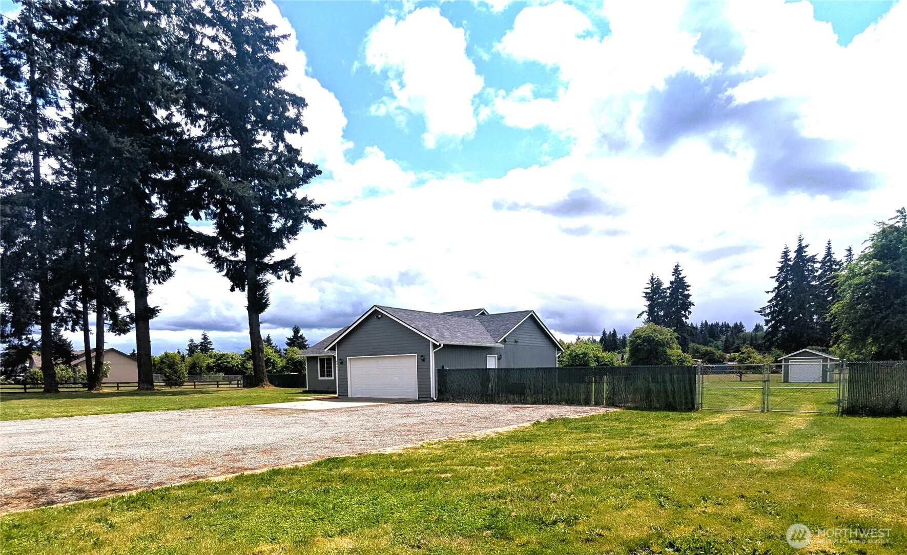 9441 180th Way Southwest Rochester, WA 98579 - Photo 1 of 37 a front view of a house with a yard and trees