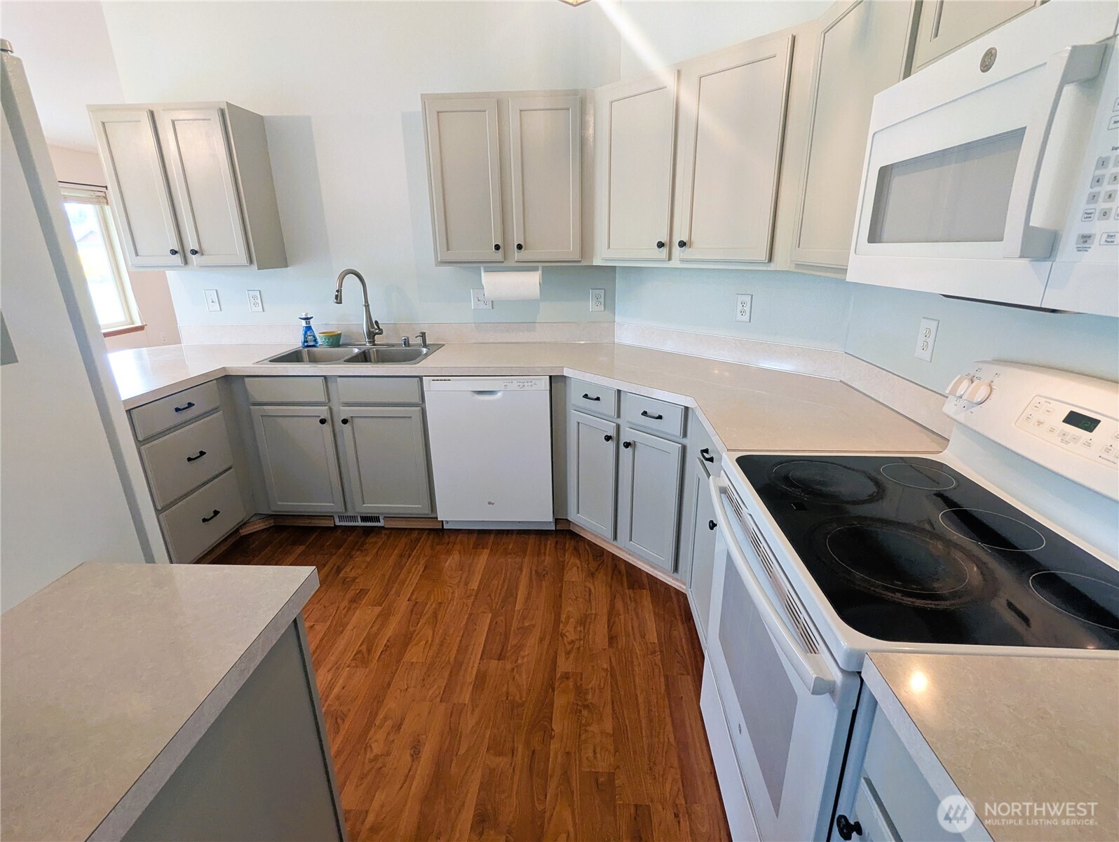 9441 180th Way Southwest Rochester, WA 98579 - Photo 12 of 37 a kitchen with a sink a stove and cabinets