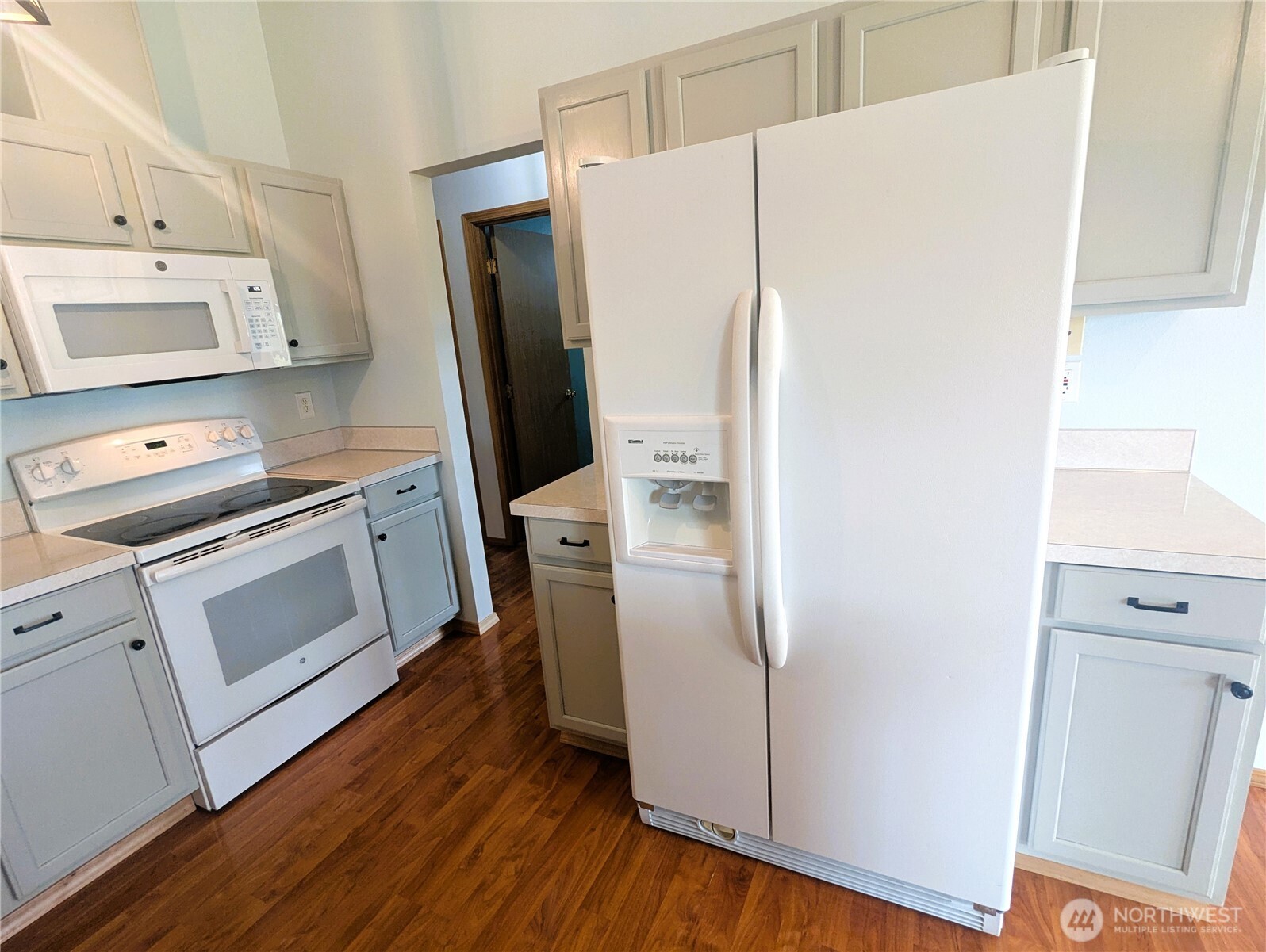 9441 180th Way Southwest Rochester, WA 98579 - Photo 13 of 37 a kitchen with a refrigerator sink stove and cabinets