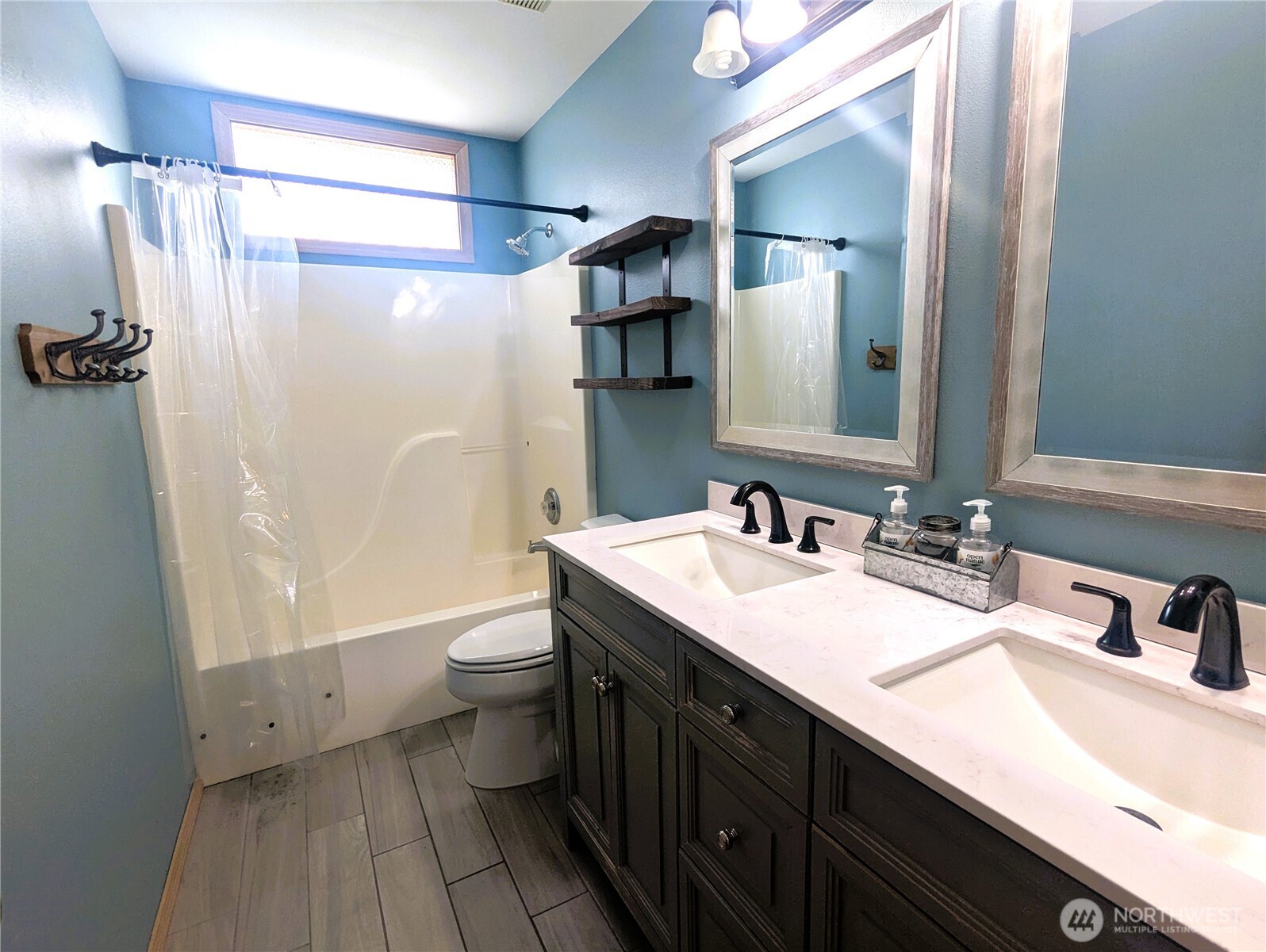 9441 180th Way Southwest Rochester, WA 98579 - Photo 17 of 37 a bathroom with a double vanity sink toilet and shower