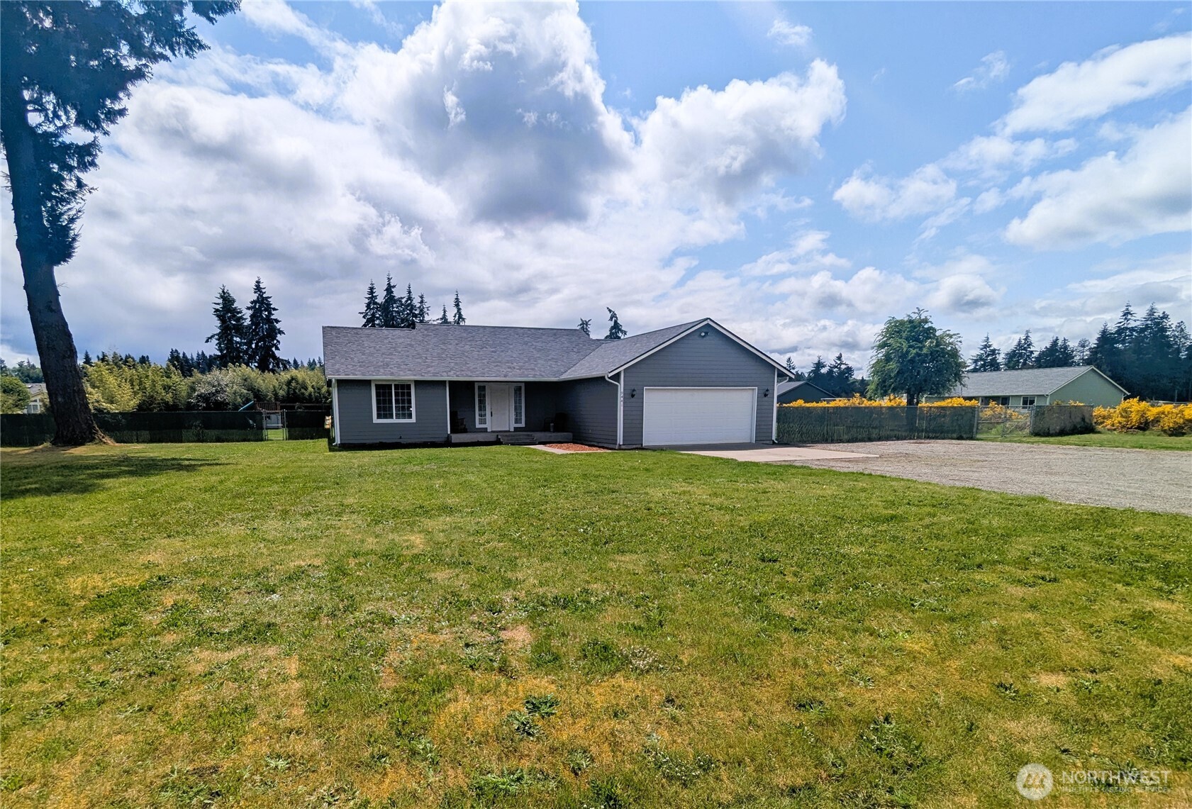 9441 180th Way Southwest Rochester, WA 98579 - Photo 2 of 37 a front view of a house with a yard