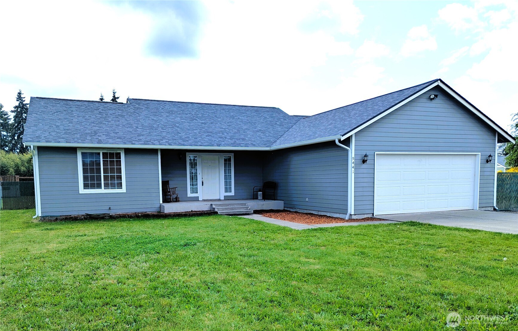 9441 180th Way Southwest Rochester, WA 98579 - Photo 3 of 37 a front view of a house with a garden and yard