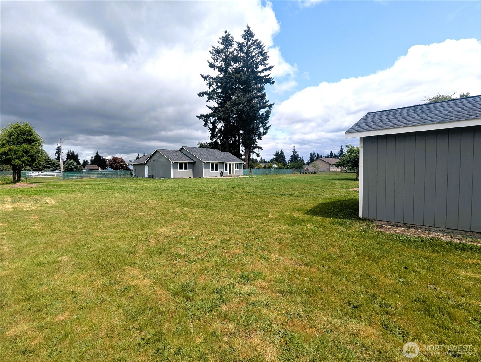 9441 180th Way Southwest Rochester, WA 98579 - Photo 35 of 37 a view of a big room with a big yard and large trees