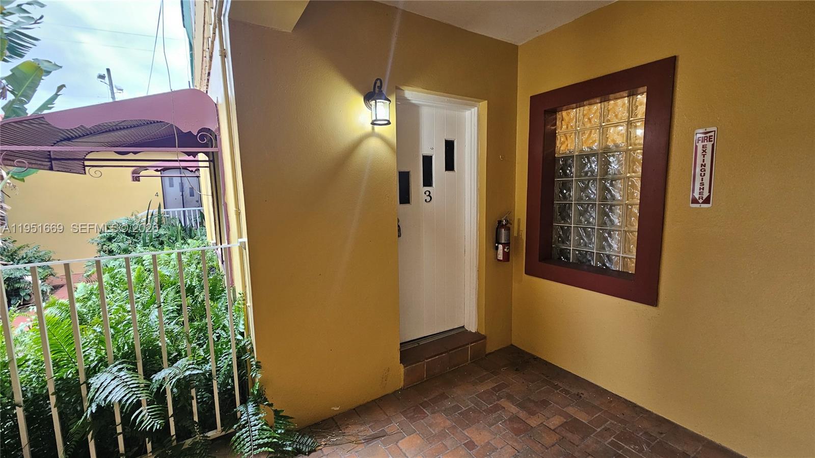 1848 Madison Street, Unit 3 Hollywood, FL 33020 - Photo 2 of 11 a view of a front door of the house and tree