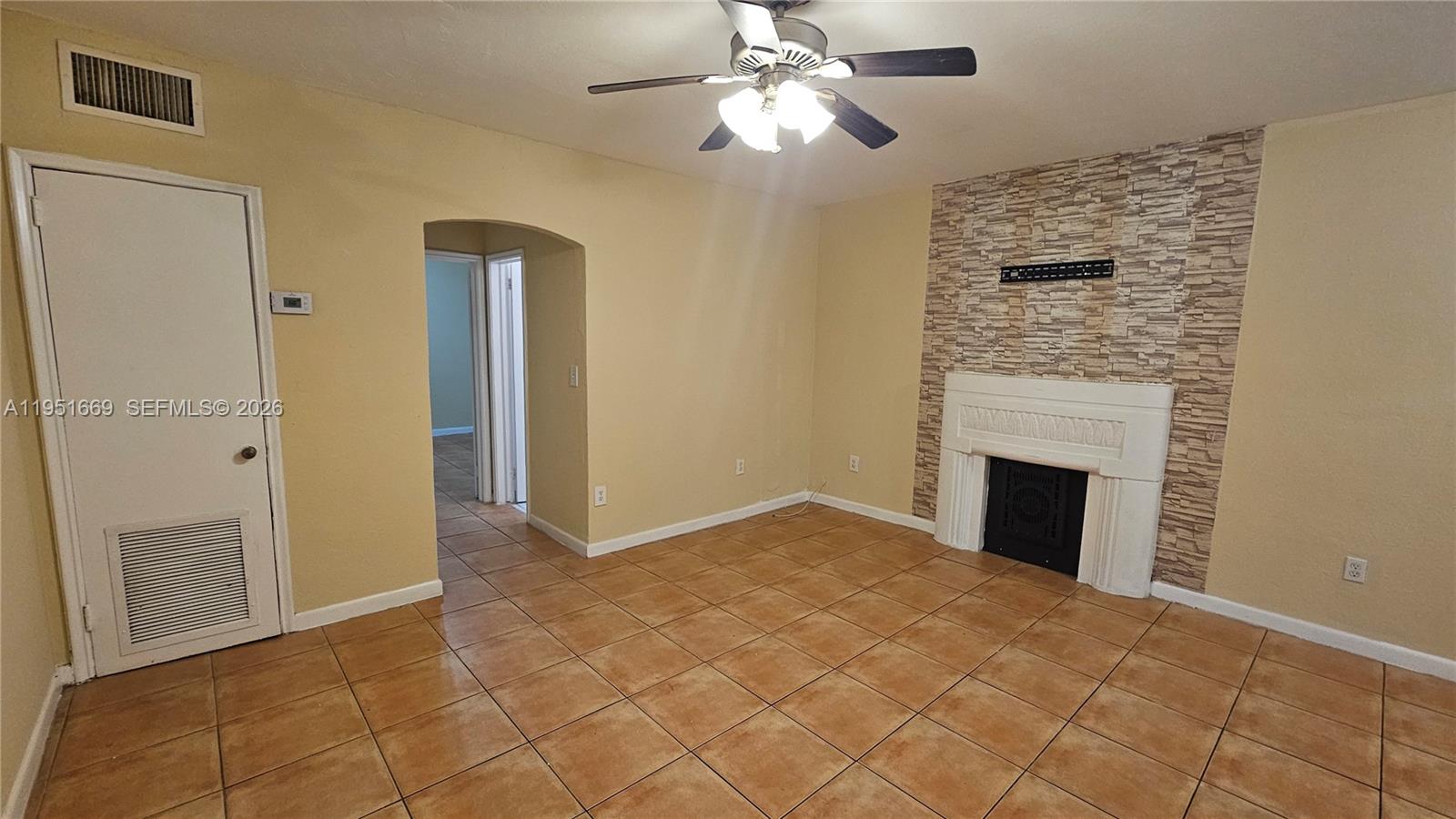 1848 Madison Street, Unit 3 Hollywood, FL 33020 - Photo 3 of 11 a view of empty room with fireplace and fan