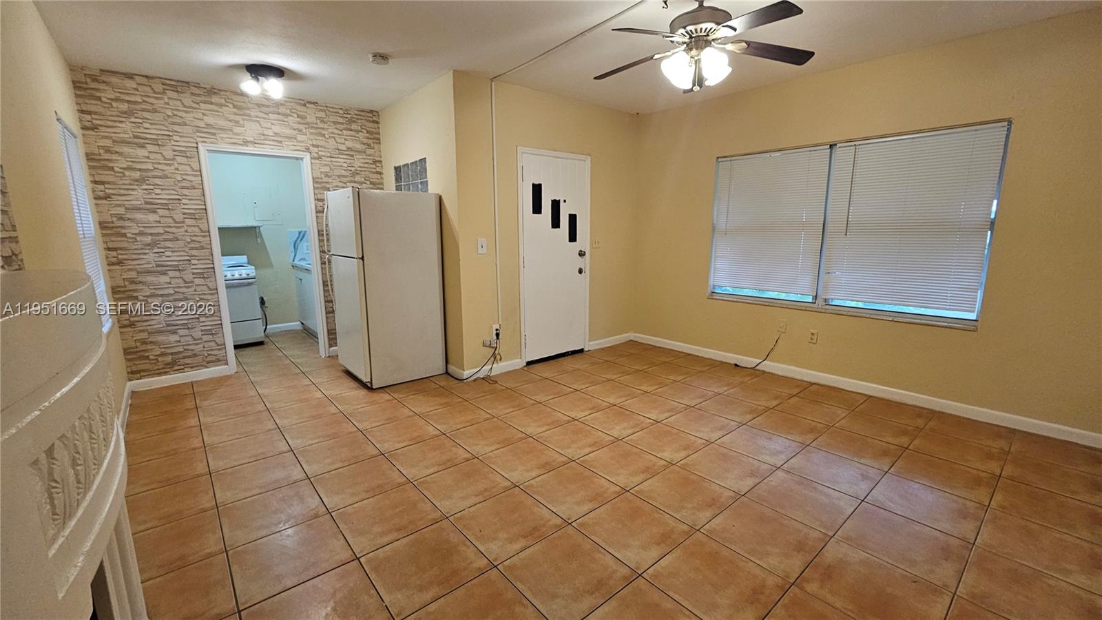 1848 Madison Street, Unit 3 Hollywood, FL 33020 - Photo 4 of 11 a view of a livingroom with a chandelier fan and windows