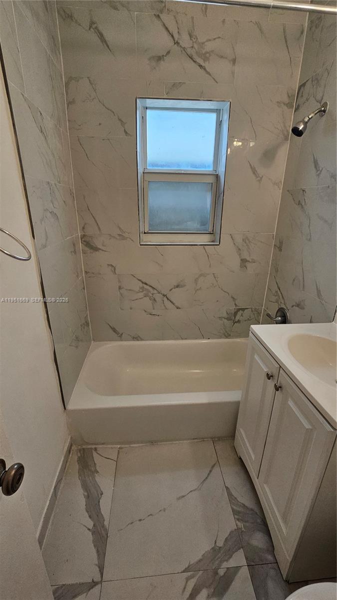 1848 Madison Street, Unit 3 Hollywood, FL 33020 - Photo 9 of 11 a bathroom with a bathtub and a shower