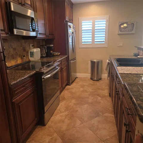 a kitchen with a stove and a microwave