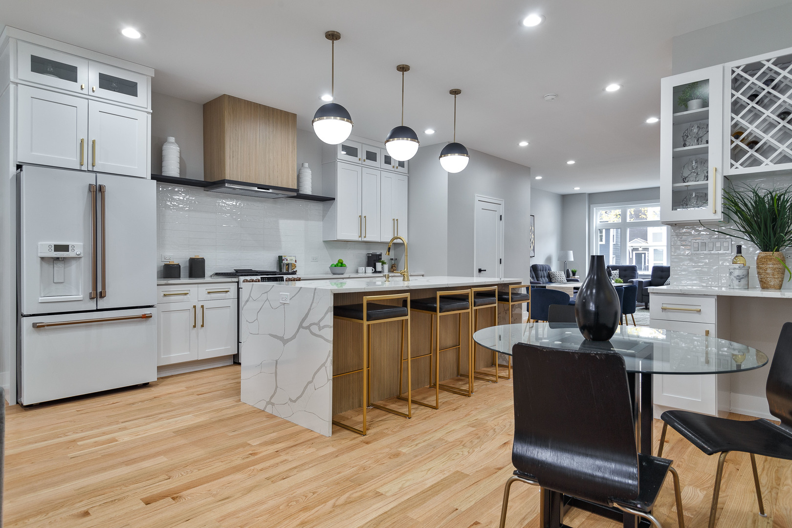 4602 North Springfield Avenue Chicago, IL 60625 - Photo 2 of 30 a large kitchen with cabinets wooden floor stainless steel appliances and dining table