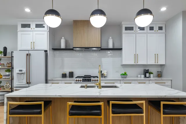 a kitchen with cabinets and chandelier