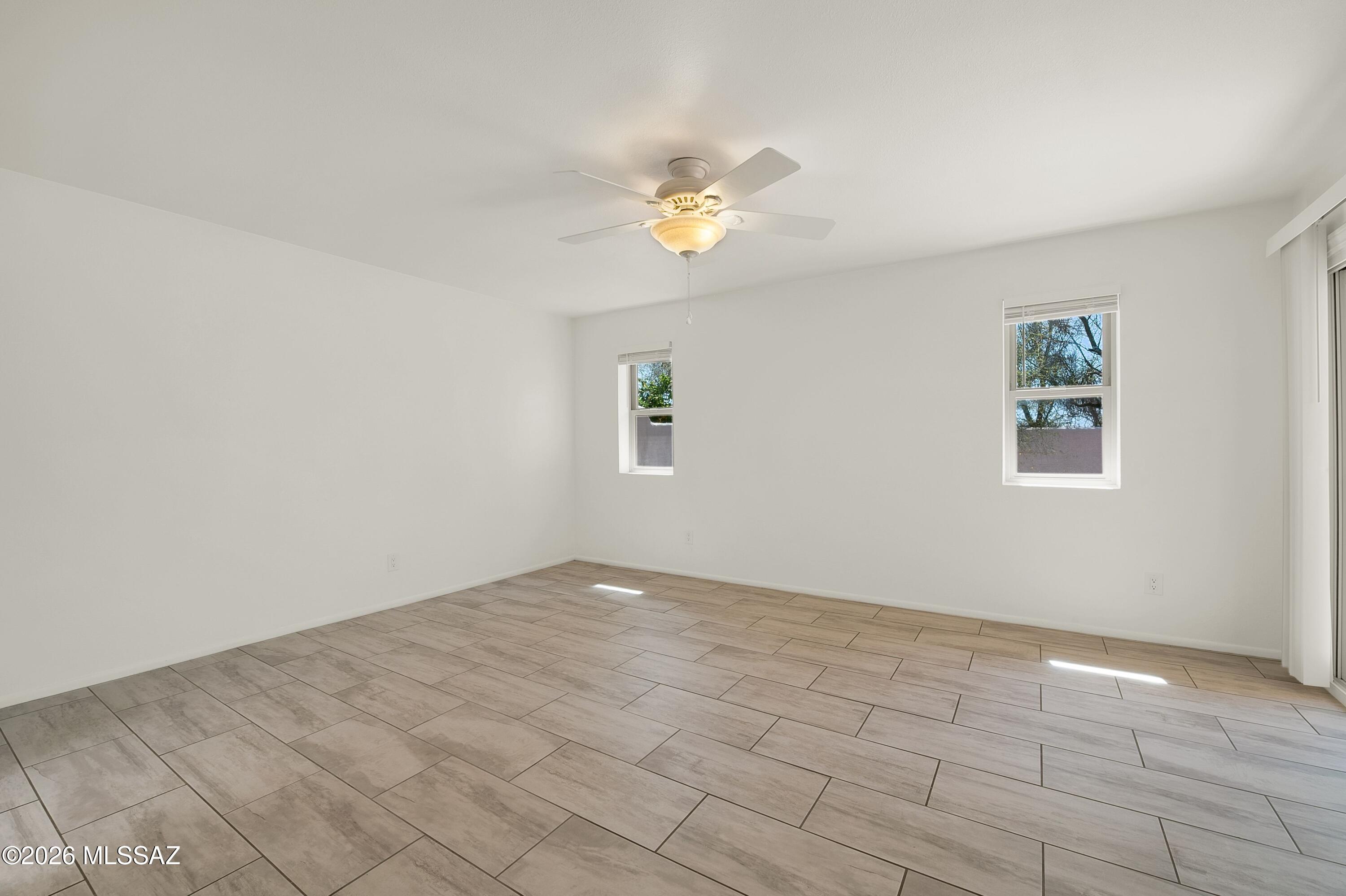 7408 East Wandering Road Tucson, AZ 85750 - Photo 14 of 25 wooden floor in an empty room with a window