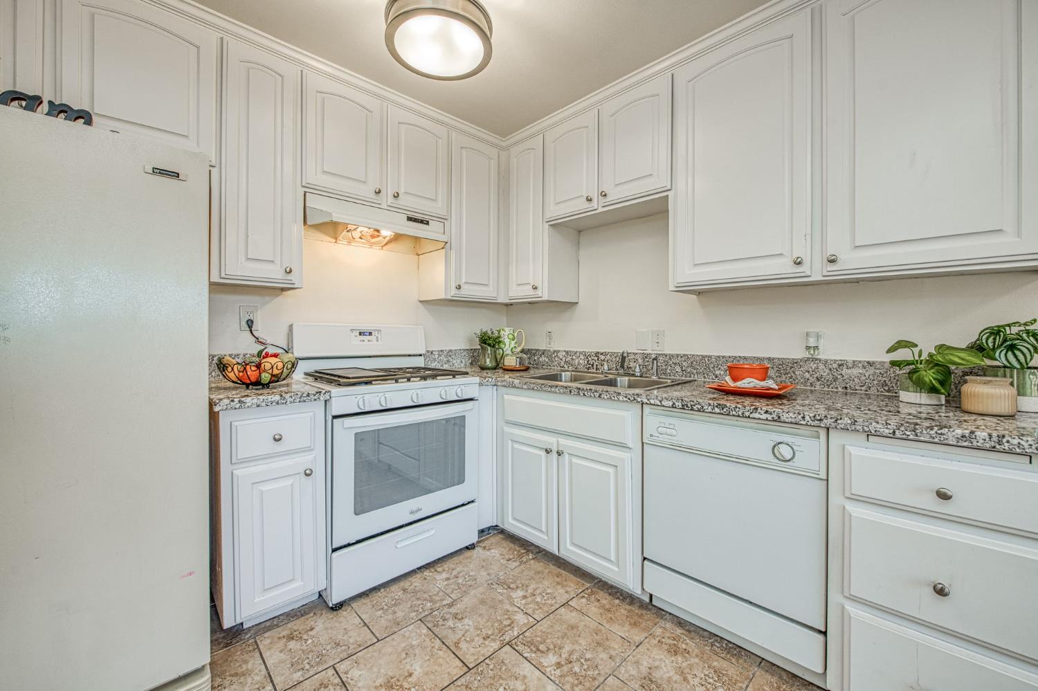 6656 North 3rd Street Fresno, CA 93710 - Photo 12 of 31 a kitchen with granite countertop white cabinets and white appliances