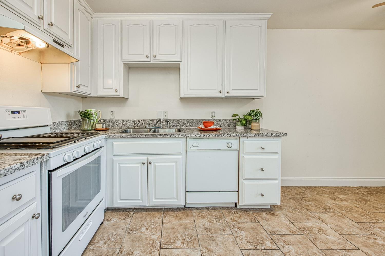 6656 North 3rd Street Fresno, CA 93710 - Photo 13 of 31 a kitchen with granite countertop white cabinets and sink