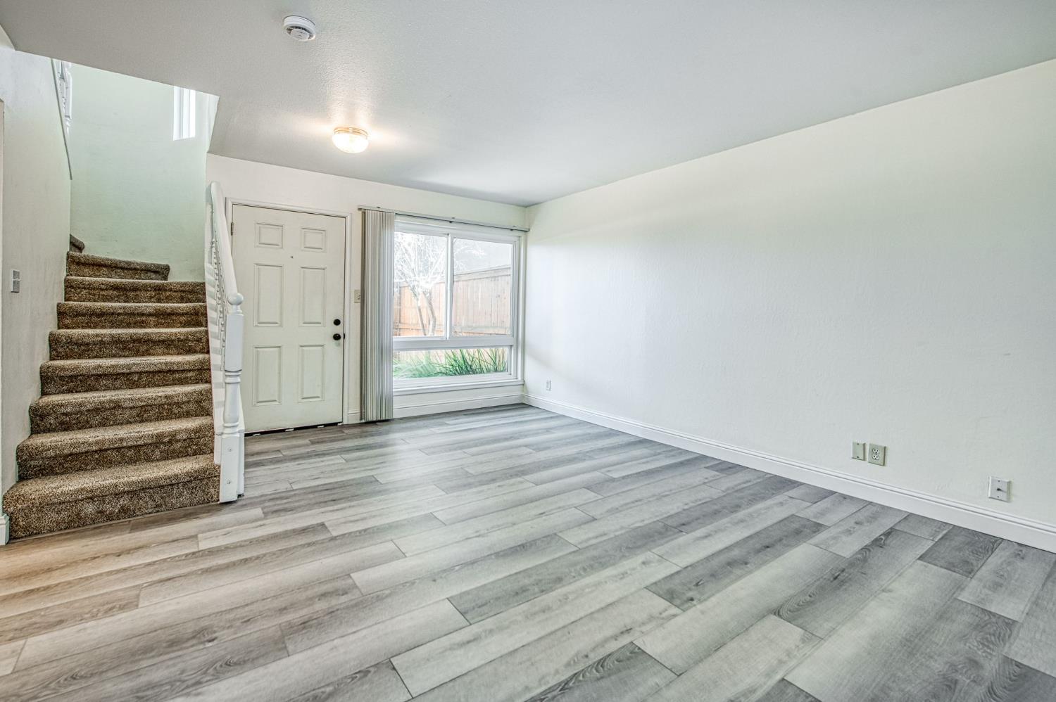 6656 North 3rd Street Fresno, CA 93710 - Photo 17 of 31 a view of a room with wooden floor and stairs