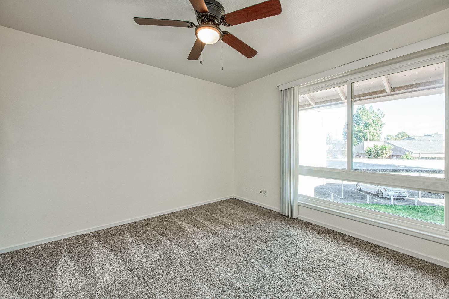 6656 North 3rd Street Fresno, CA 93710 - Photo 19 of 31 an empty room with a window and a ceiling fan