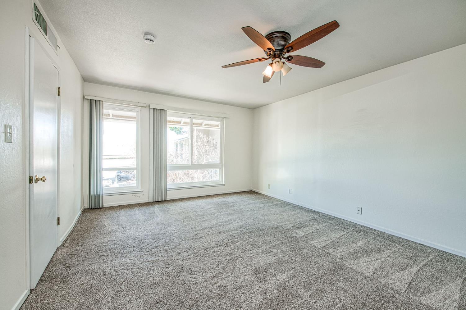 6656 North 3rd Street Fresno, CA 93710 - Photo 20 of 31 a view of an empty room with window and a ceiling fan