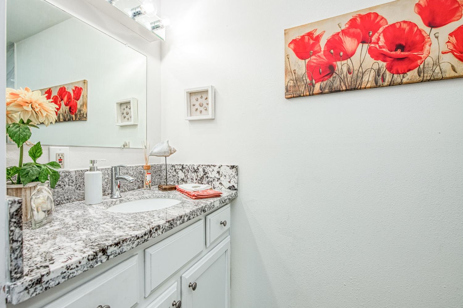 6656 North 3rd Street Fresno, CA 93710 - Photo 23 of 31 a bathroom with a granite countertop sink and a mirror