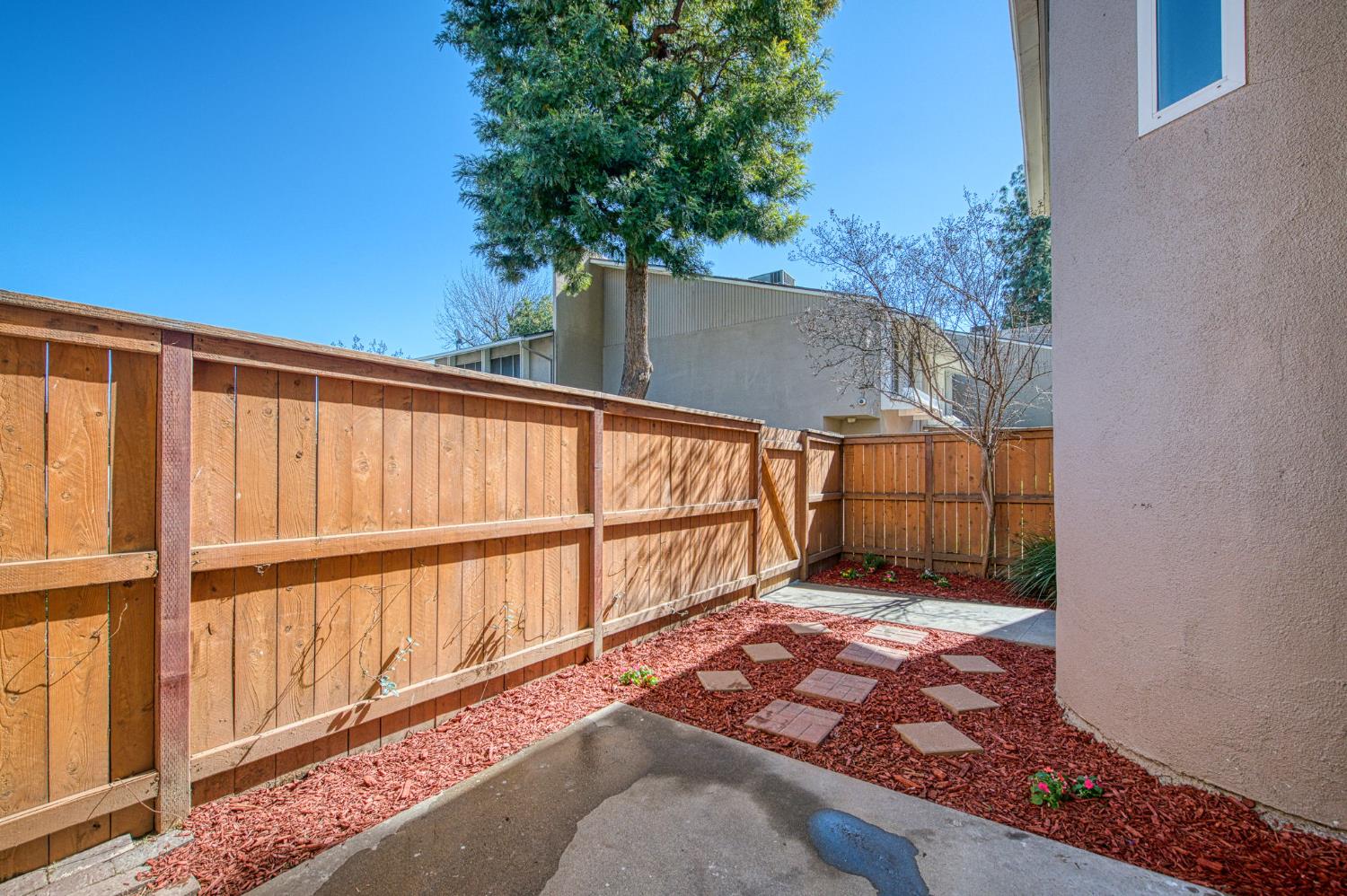 6656 North 3rd Street Fresno, CA 93710 - Photo 25 of 31 a view of backyard with large trees and wooden fence