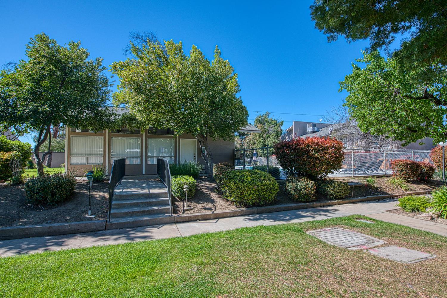 6656 North 3rd Street Fresno, CA 93710 - Photo 29 of 31 a view of a patio with table and chairs plants and large tree