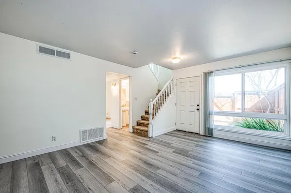 a view of a hallway with wooden floor