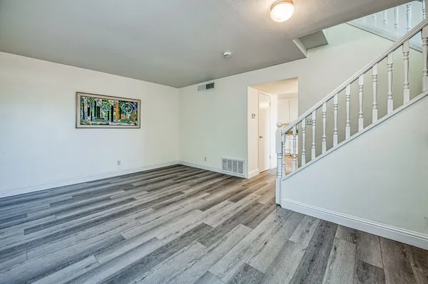 a view of entryway with wooden floor and stairs