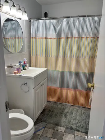 a bathroom with a sink a toilet and a shower