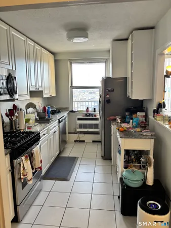 a kitchen with a sink a stove and cabinets