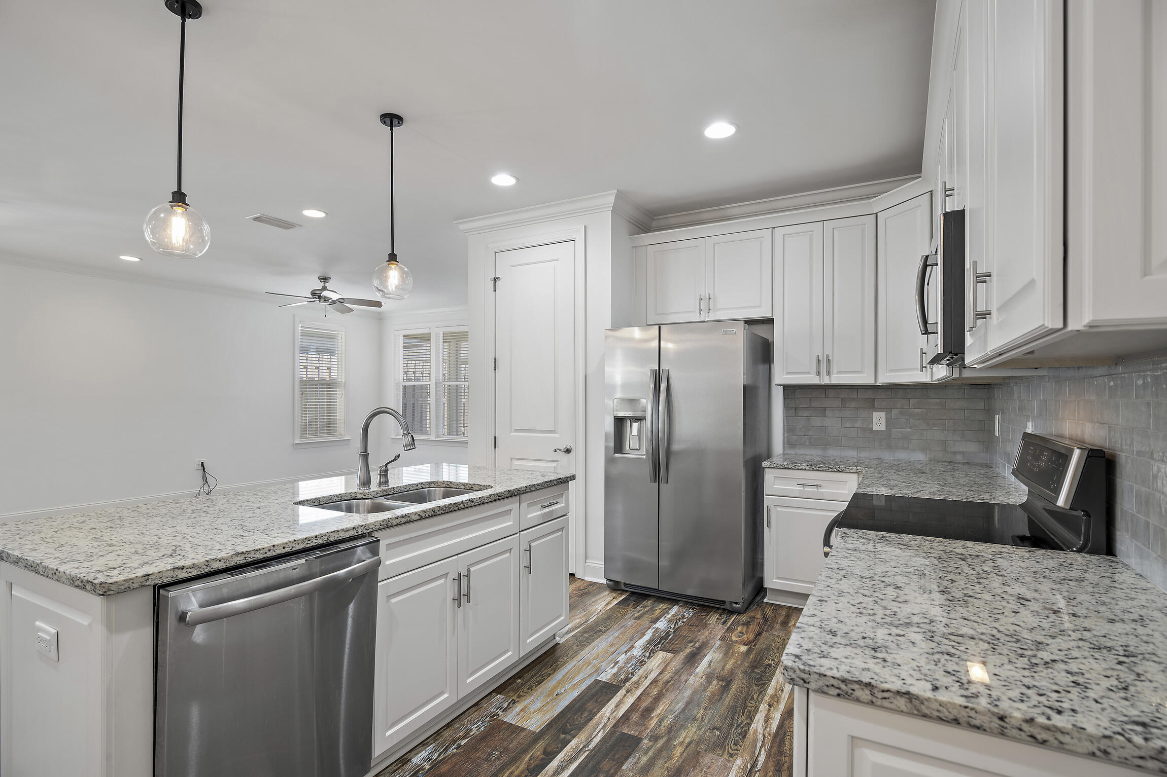193 Christian Drive Santa Rosa Beach, FL 32459 - Photo 11 of 41 a kitchen with stainless steel appliances granite countertop a sink a refrigerator and a granite counter tops