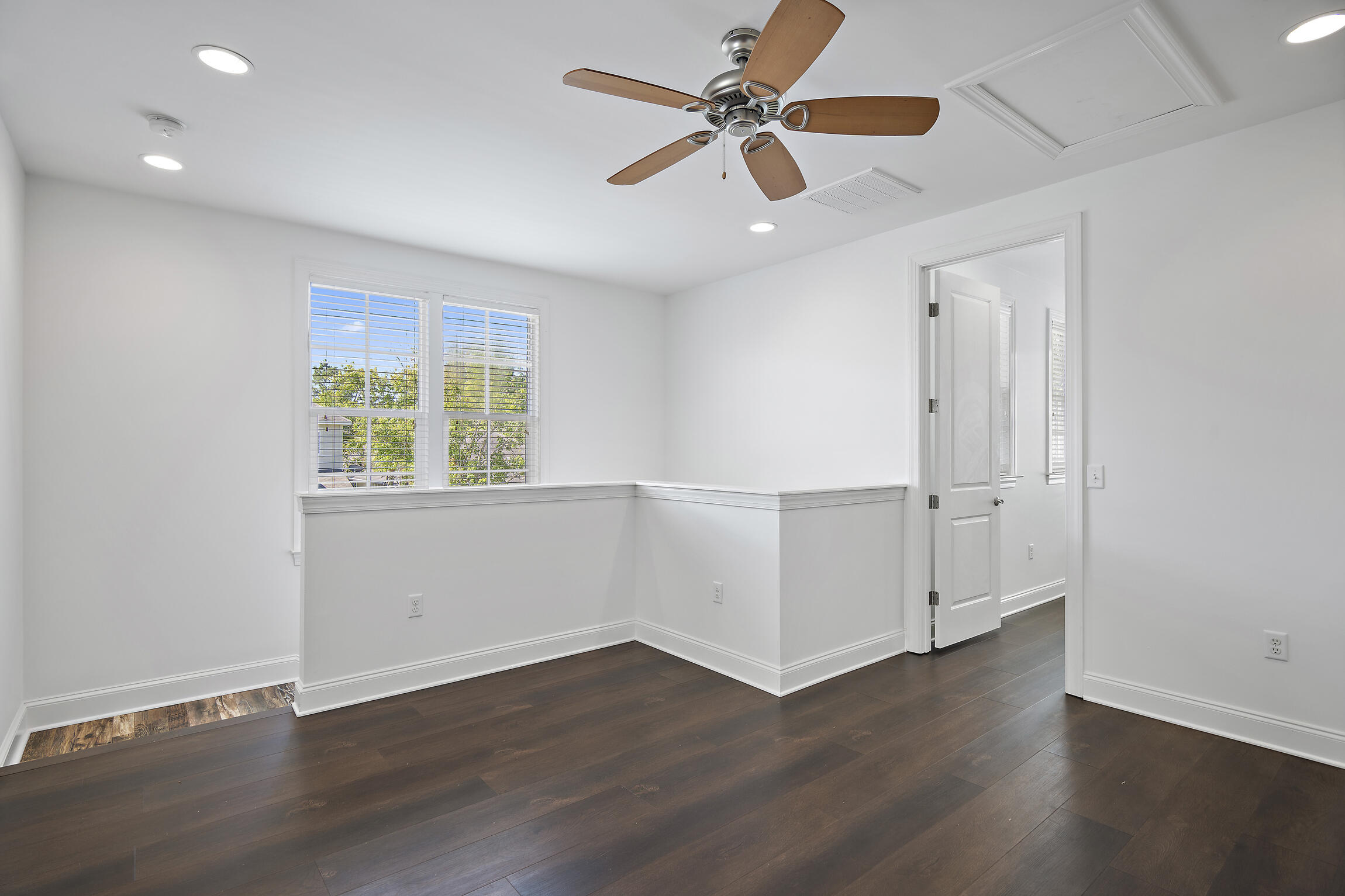 193 Christian Drive Santa Rosa Beach, FL 32459 - Photo 24 of 41 an empty room with wooden floor chandelier fan and windows