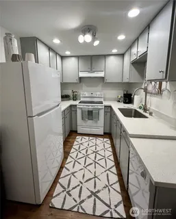 a kitchen with sink cabinets and refrigerator