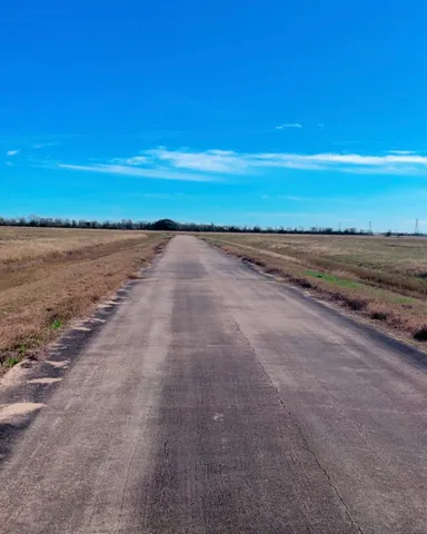 a view of a balcony with lake and trees in the background
