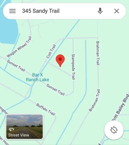 a view of a lake with houses in the background